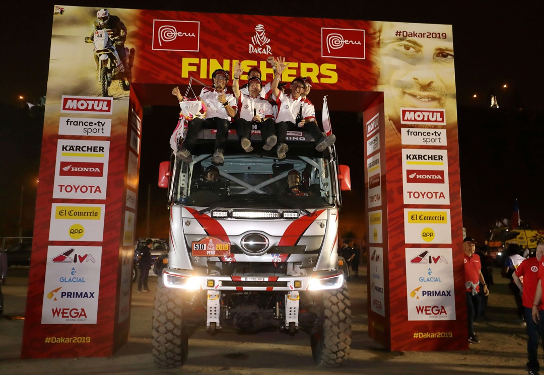 Hino Team Sugawara members bask in the glory at the finish ceremony.