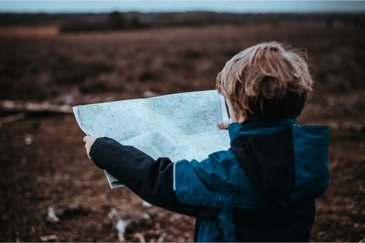 child reading a road map