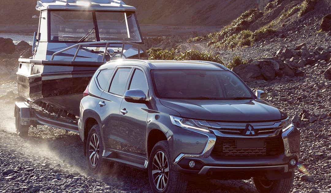 Mitsubishi Towing Boat on Gravel Track