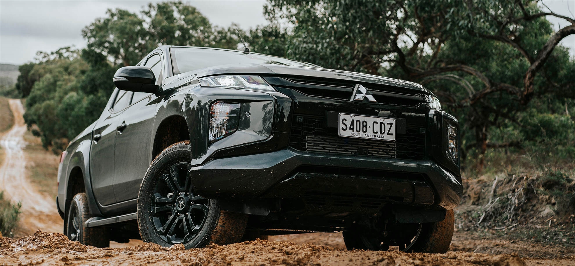 Triton Driving On Muddy Road