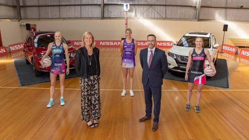 Jo Weston, Marne Fechner, Gretel Tippet, Stephen Lester, and Hannah Petty standing together on netball court